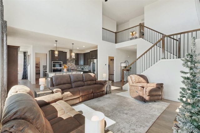 living room featuring wood-type flooring and a high ceiling