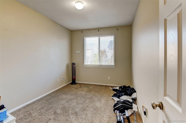 carpeted spare room featuring a textured ceiling