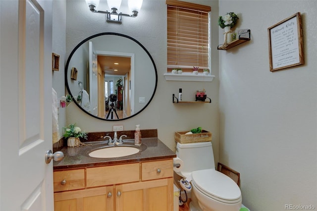 bathroom with vanity and toilet