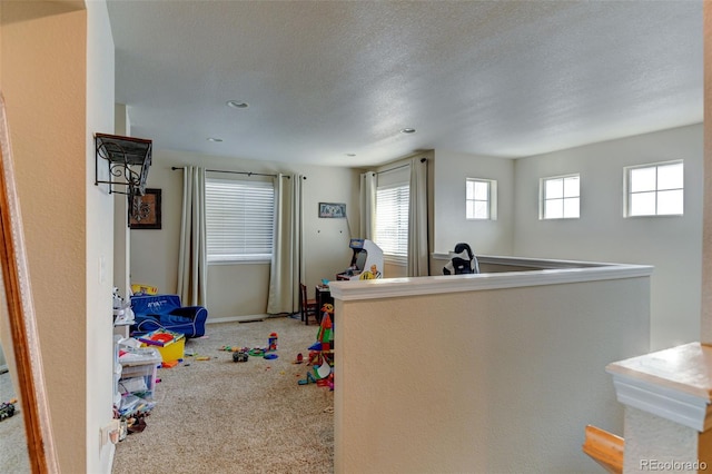 interior space featuring carpet and a textured ceiling