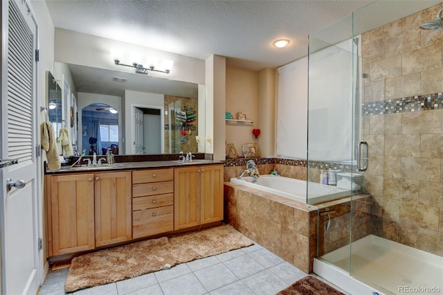 bathroom with vanity, shower with separate bathtub, tile patterned flooring, and a textured ceiling