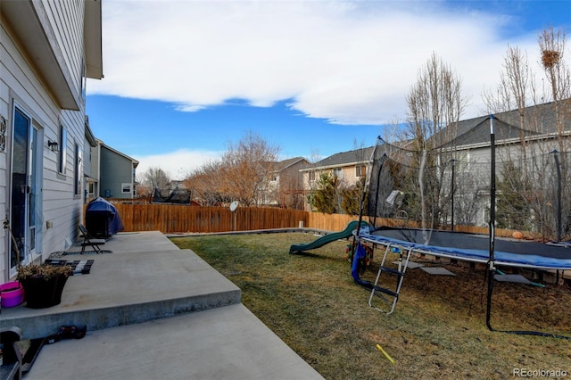 view of yard featuring a playground, a patio, and a trampoline