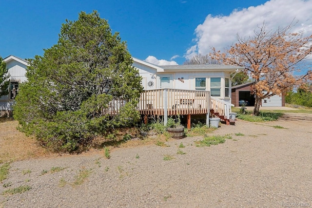 view of front of home with a garage and a wooden deck