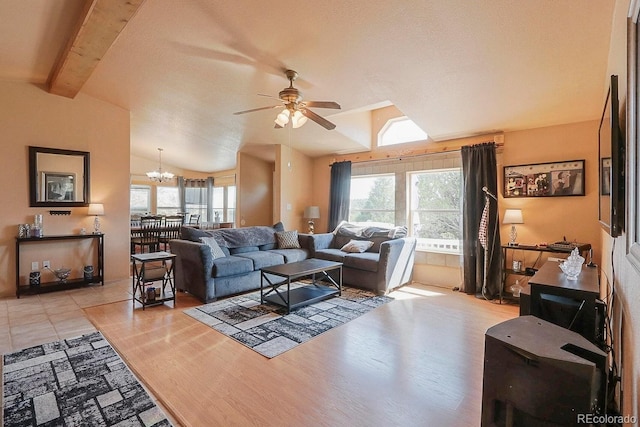 living room featuring vaulted ceiling with beams, a wealth of natural light, light hardwood / wood-style floors, and ceiling fan with notable chandelier