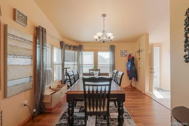 dining room featuring a chandelier, hardwood / wood-style flooring, and a wealth of natural light