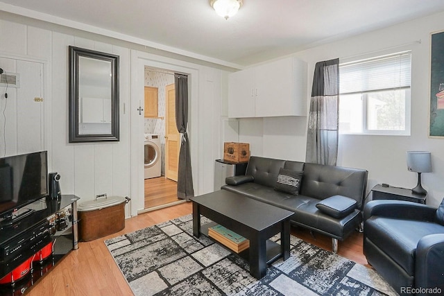 living room with hardwood / wood-style flooring and washer / clothes dryer