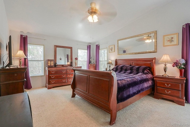 bedroom featuring ceiling fan, light colored carpet, and vaulted ceiling