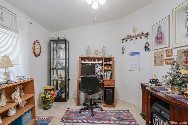 carpeted office space with vaulted ceiling