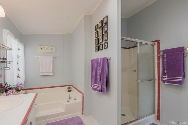 bathroom with vanity, tile patterned floors, crown molding, and separate shower and tub