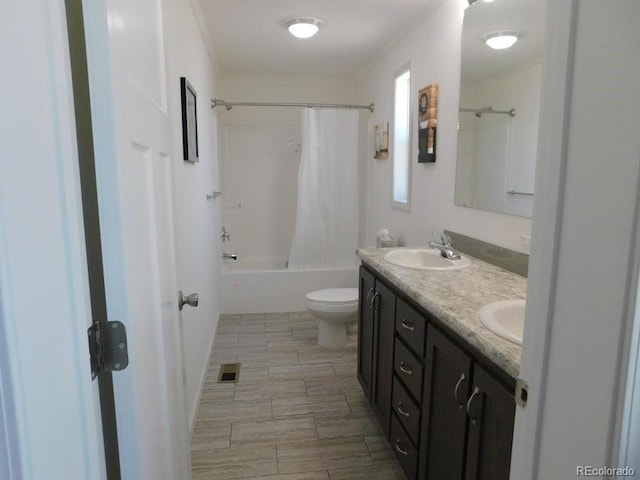 full bathroom featuring toilet, tile patterned floors, double sink vanity, and shower / tub combo