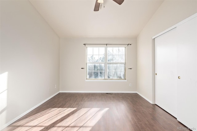 unfurnished room featuring ceiling fan and dark wood-type flooring