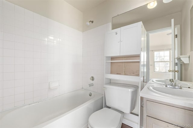 full bathroom with vanity, tiled shower / bath combo, and toilet