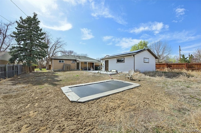 11360 Irma Dr, Northglenn, CO 80233 - rear view of property with a fenced backyard and solar panels