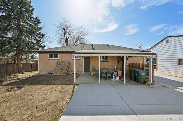 11360 Irma Dr, Northglenn, CO 80233 - back of property with a patio area, brick siding, and roof with shingles