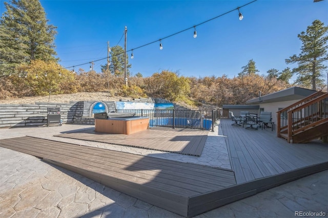 wooden terrace with a hot tub