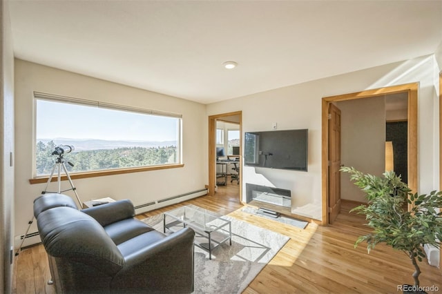 living room with light hardwood / wood-style flooring and baseboard heating