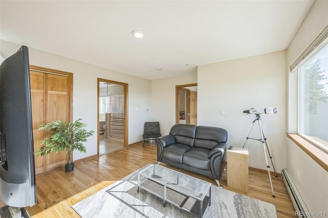 living room with light hardwood / wood-style floors and a baseboard radiator