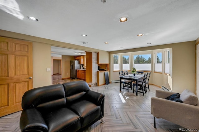 living room with light parquet floors and a baseboard heating unit