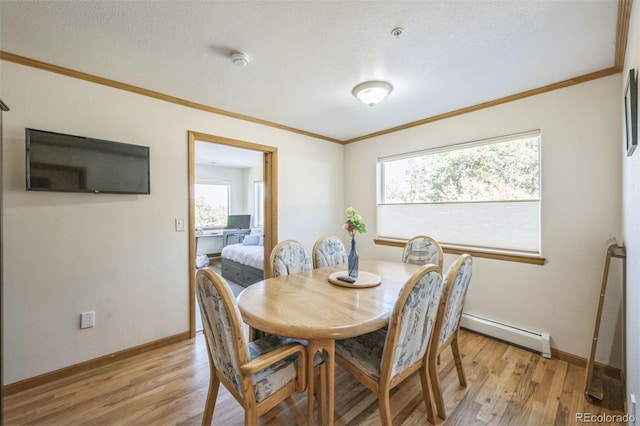 dining area featuring light hardwood / wood-style floors, ornamental molding, a textured ceiling, and a baseboard radiator