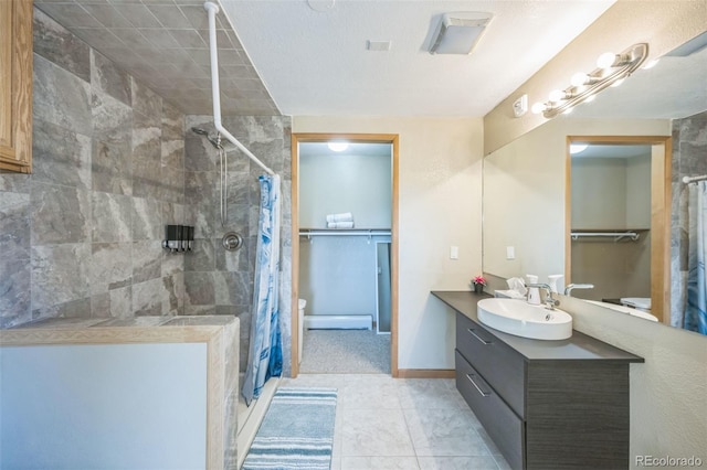 bathroom featuring tile patterned floors, vanity, toilet, and walk in shower