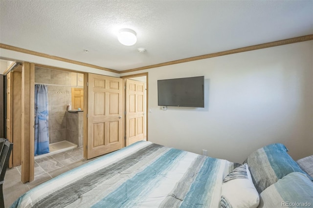 bedroom with a textured ceiling, connected bathroom, and ornamental molding