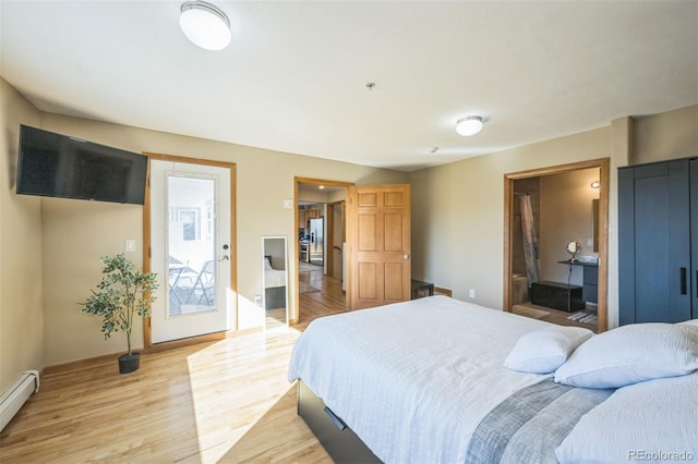 bedroom with light hardwood / wood-style floors, connected bathroom, and a baseboard radiator