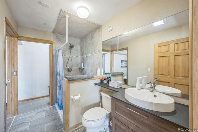 bathroom with a shower with shower curtain, vanity, and toilet