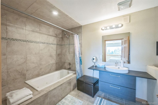 bathroom with tile patterned floors, vanity, and shower / bath combo with shower curtain