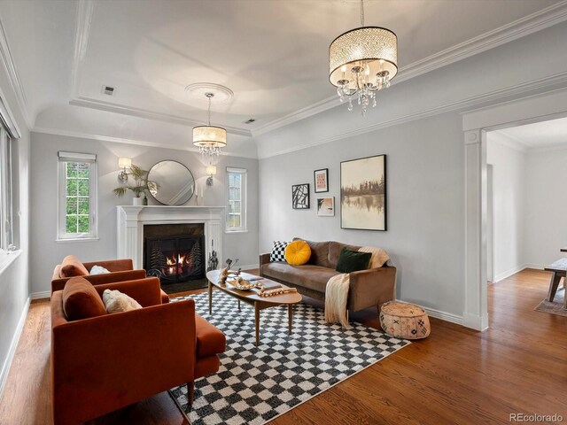 405 S University Blvd, Denver, CO 80209 - living area featuring a tray ceiling, wood finished floors, a fireplace with flush hearth, baseboards, and a chandelier