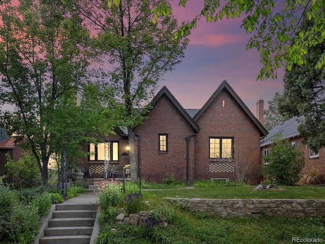 405 S University Blvd, Denver, CO 80209 - tudor home with brick siding, stairs, and a front yard