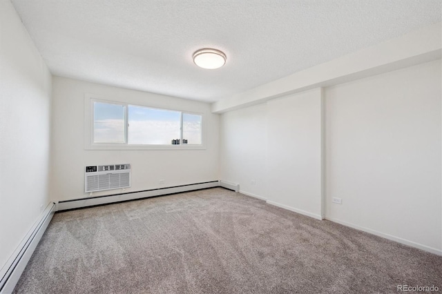 1029 E 8th Ave Unit 603, Denver, CO 80218 - spare room featuring a baseboard radiator, a wall mounted air conditioner, carpet floors, a baseboard heating unit, and a textured ceiling