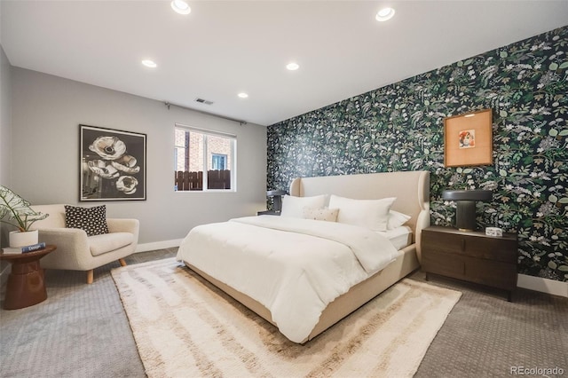 carpeted bedroom with wallpapered walls, visible vents, baseboards, and recessed lighting