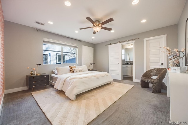 bedroom featuring recessed lighting, carpet flooring, baseboards, and a barn door