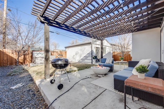 view of patio / terrace with a fire pit, an outbuilding, a fenced backyard, and a pergola