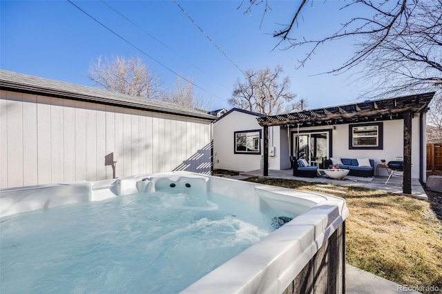 back of property with a hot tub, outdoor lounge area, and a patio