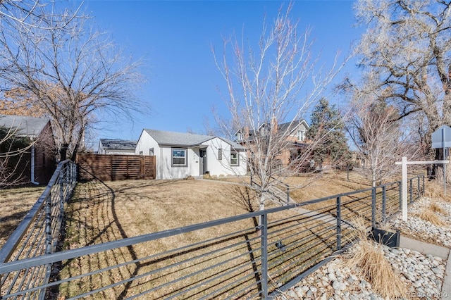 view of yard with driveway and a fenced front yard