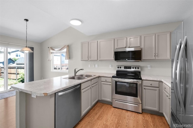 3456 Osprey Ridge Dr, Colorado Springs, CO 80916 - kitchen with stainless steel appliances, a sink, gray cabinets, a peninsula, and vaulted ceiling