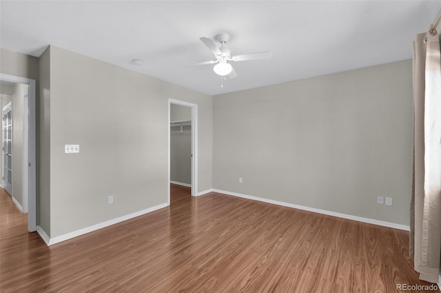 3456 Osprey Ridge Dr, Colorado Springs, CO 80916 - unfurnished bedroom with wood finished floors, baseboards, a walk in closet, and a closet