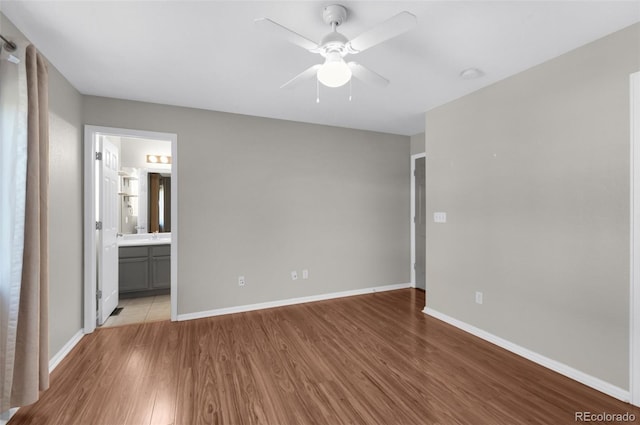 3456 Osprey Ridge Dr, Colorado Springs, CO 80916 - unfurnished bedroom with light wood finished floors, baseboards, ensuite bath, and a ceiling fan