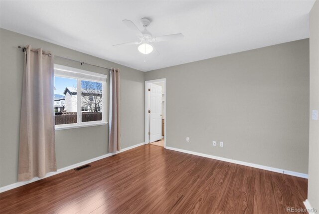 3456 Osprey Ridge Dr, Colorado Springs, CO 80916 - empty room with wood finished floors, a ceiling fan, and baseboards