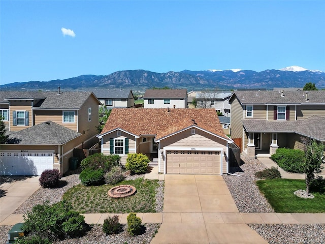 3456 Osprey Ridge Dr, Colorado Springs, CO 80916 - traditional home with concrete driveway, a mountain view, a residential view, and an attached garage