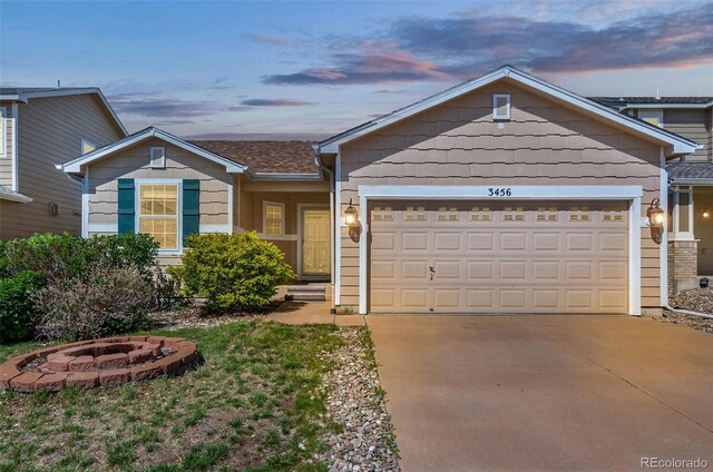 3456 Osprey Ridge Dr, Colorado Springs, CO 80916 - single story home with an outdoor fire pit, concrete driveway, and an attached garage