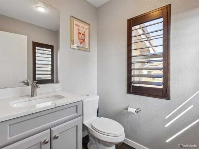 11426 Box Turtle Ct, Parker, CO 80134 - half bath featuring toilet, vanity, and baseboards