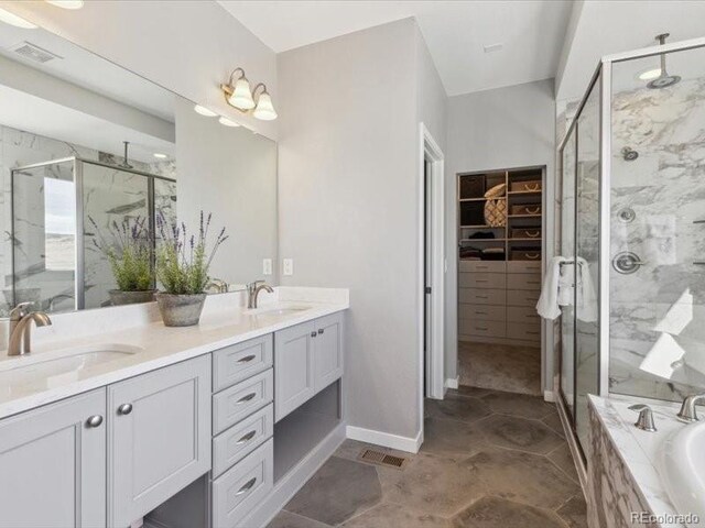 11426 Box Turtle Ct, Parker, CO 80134 - full bathroom with a marble finish shower, double vanity, a bath, and a walk in closet