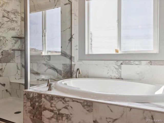 11426 Box Turtle Ct, Parker, CO 80134 - bathroom featuring a bath and a marble finish shower