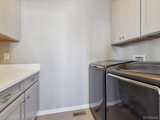 11426 Box Turtle Ct, Parker, CO 80134 - laundry room featuring washer and dryer, cabinet space, and baseboards