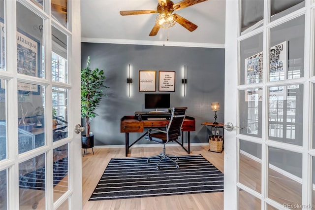 home office featuring wood finished floors, a ceiling fan, ornamental molding, french doors, and baseboards