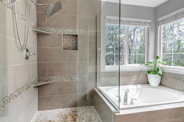 full bath with a bath and tiled shower