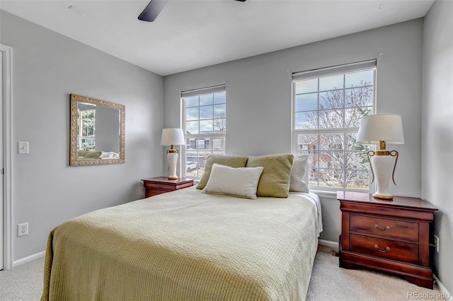 carpeted bedroom featuring a ceiling fan and baseboards