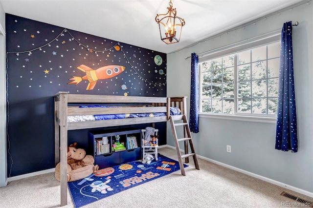 carpeted bedroom with baseboards, visible vents, and an inviting chandelier